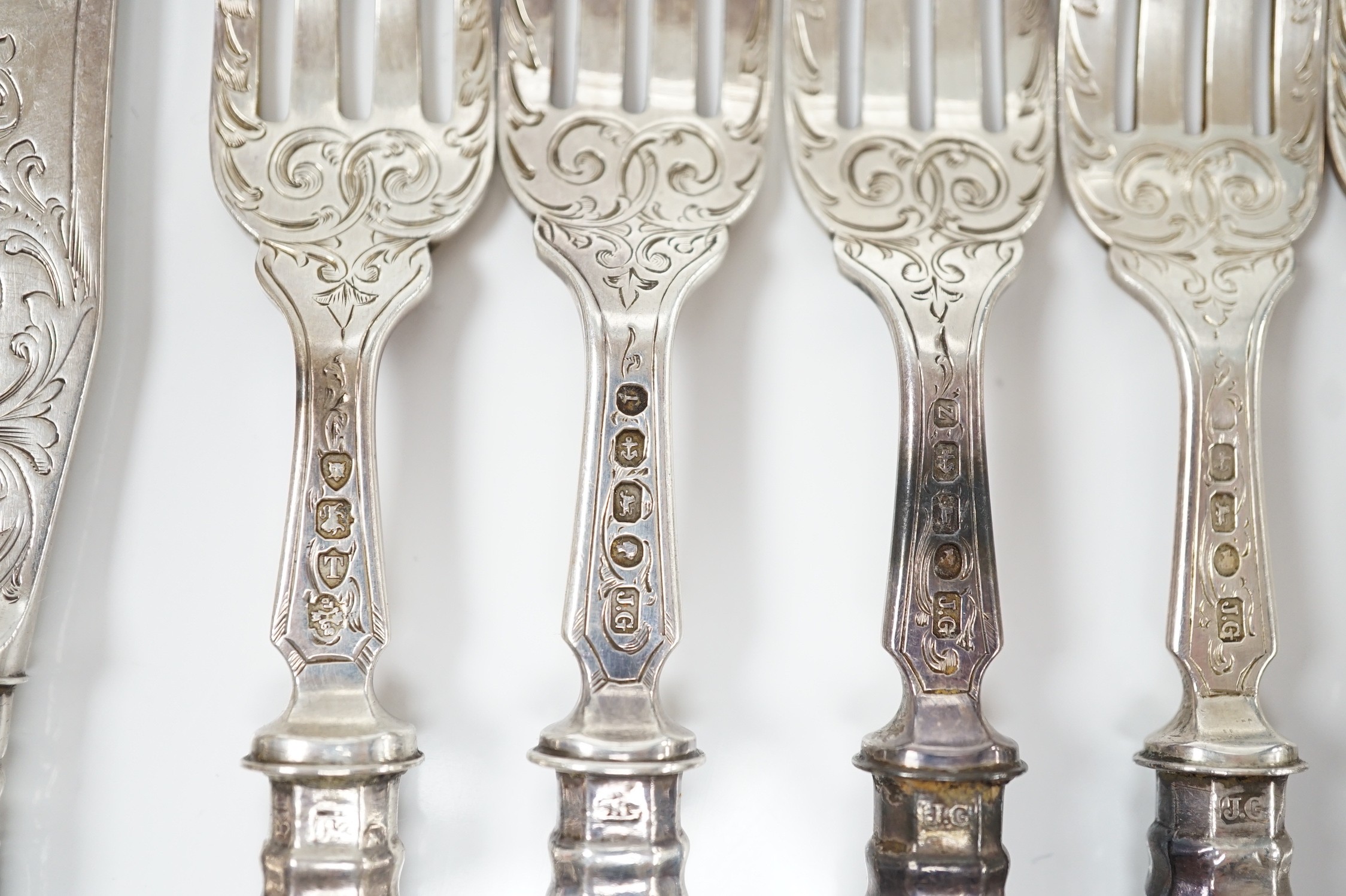 A set of ten pairs of Victorian silver Queen's pattern dessert eaters, maker, JG, Birmingham, 1856/7, loaded handles.
